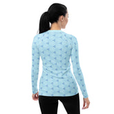 Women's UV protective rash guard with ocean design.